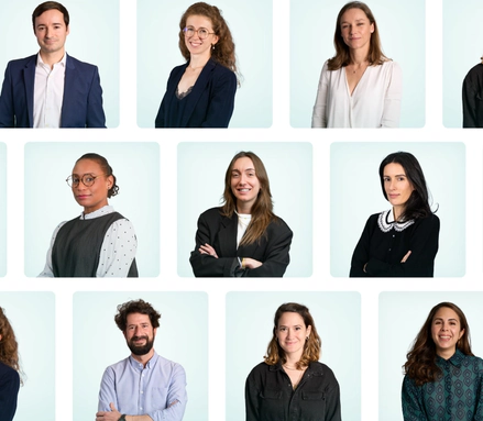 Bust portraits of nine smiling professionals against a light background, dressed in casual business attire.