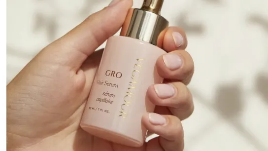 Une personne en train d'appliquer un sérum à ses cheveux