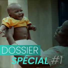 Baby carried by its mother and text "Special file #1".