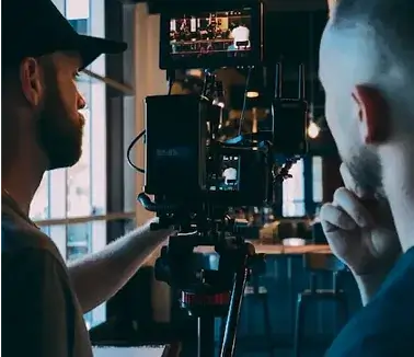 Production crew reviewing a cinema camera setup on set