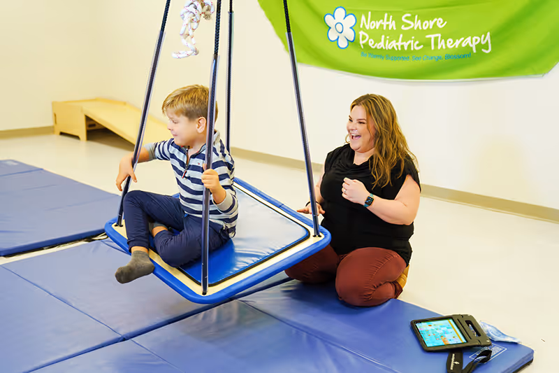 A spacious and safe therapy gym featuring swing equipment at North Shore Pediatric Therapy, Naperville, IL."
