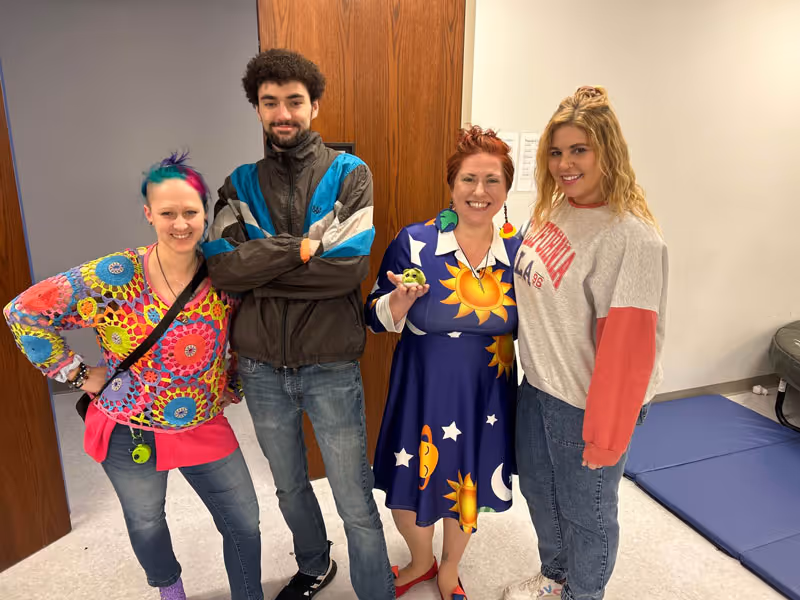 Smiling team of dedicated pediatric therapy professionals from North Shore Pediatric Therapy in Naperville, IL, posing together.
