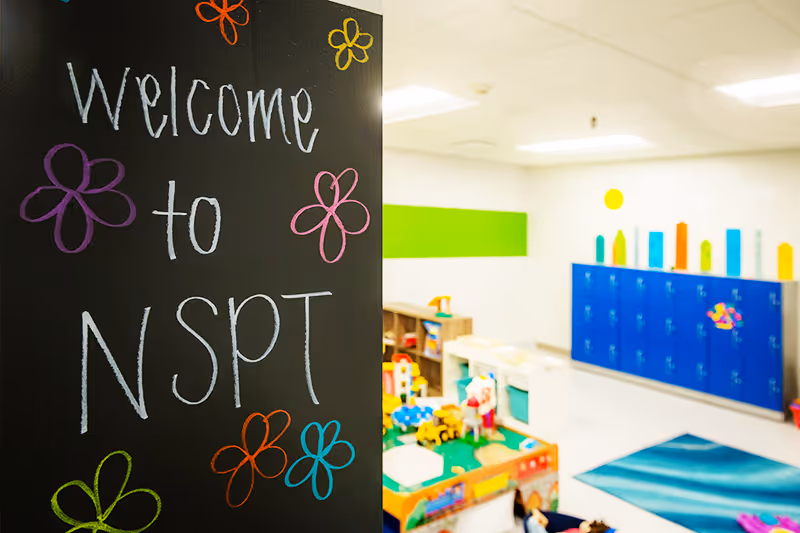 Interactive therapy room featuring sensory play equipment and a chalkboard at North Shore Pediatric Therapy.