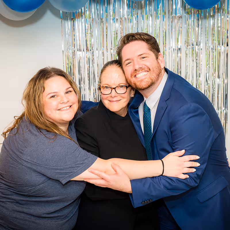 Three of our therapists celebrating our Glenview pediatric therapy center with big smiles.