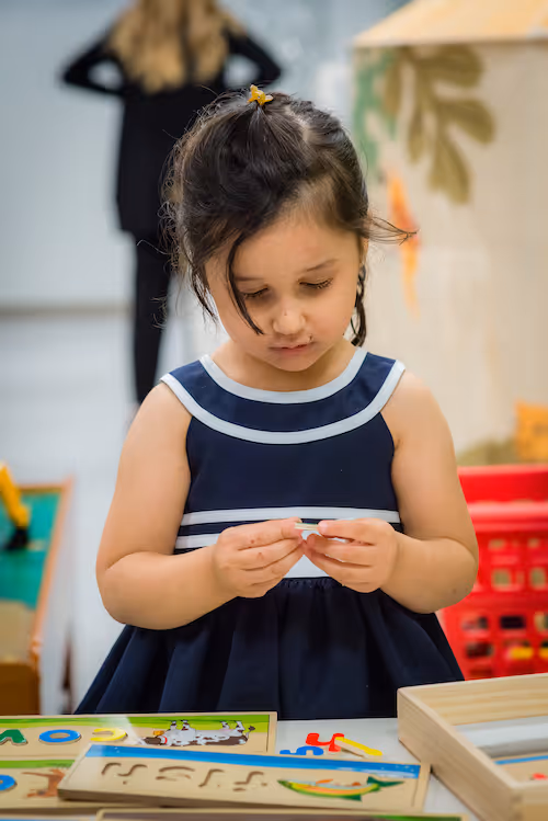 Small child at pediatric therapy working on fine motor skills