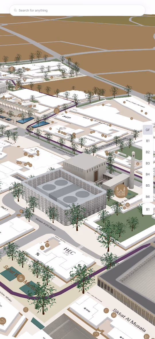 3D map view of a campus area with labeled buildings, trees, roads, and a search bar at the top.