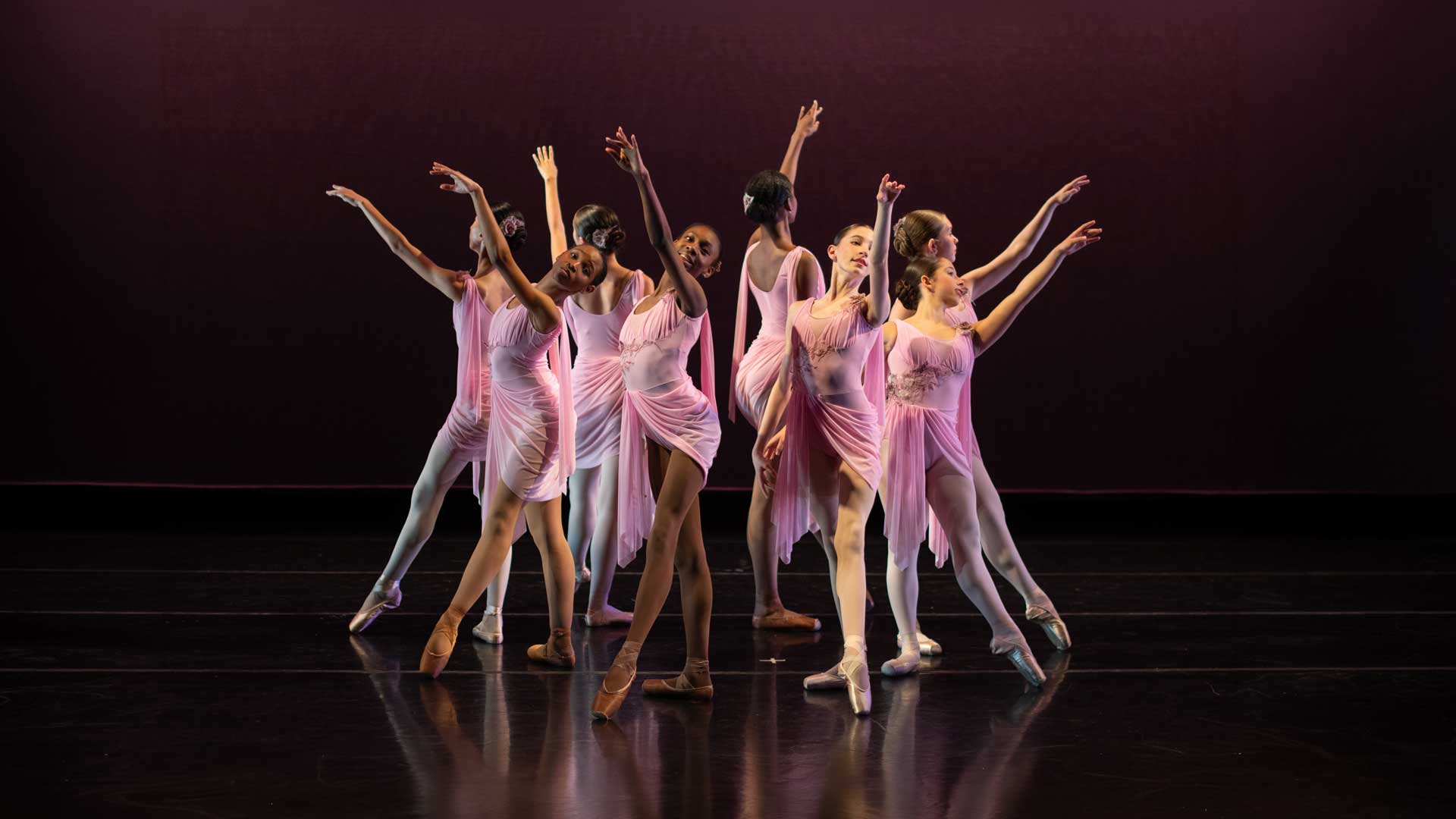 Ensemble of female dancers in pink