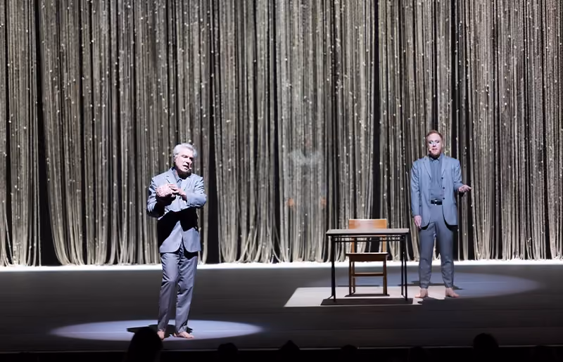 David Byrne performing inside a theater