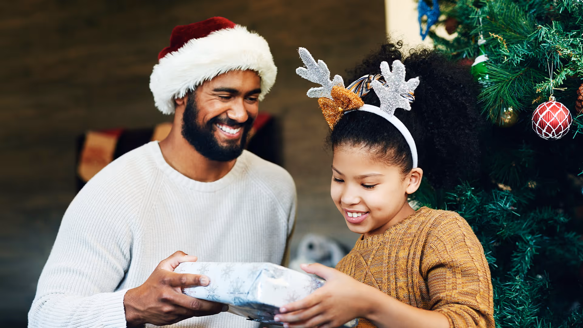 father sharing christmas gift with daughter