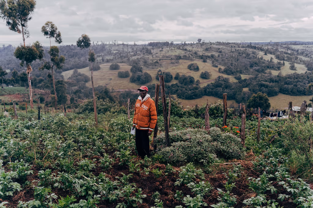 A man stands on a small piece of land that he purchased to bury his son.