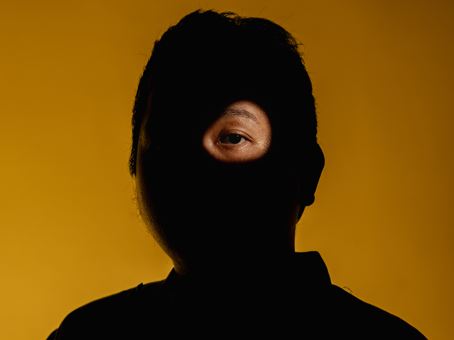 A dark image conceals a man’s identity in a photo