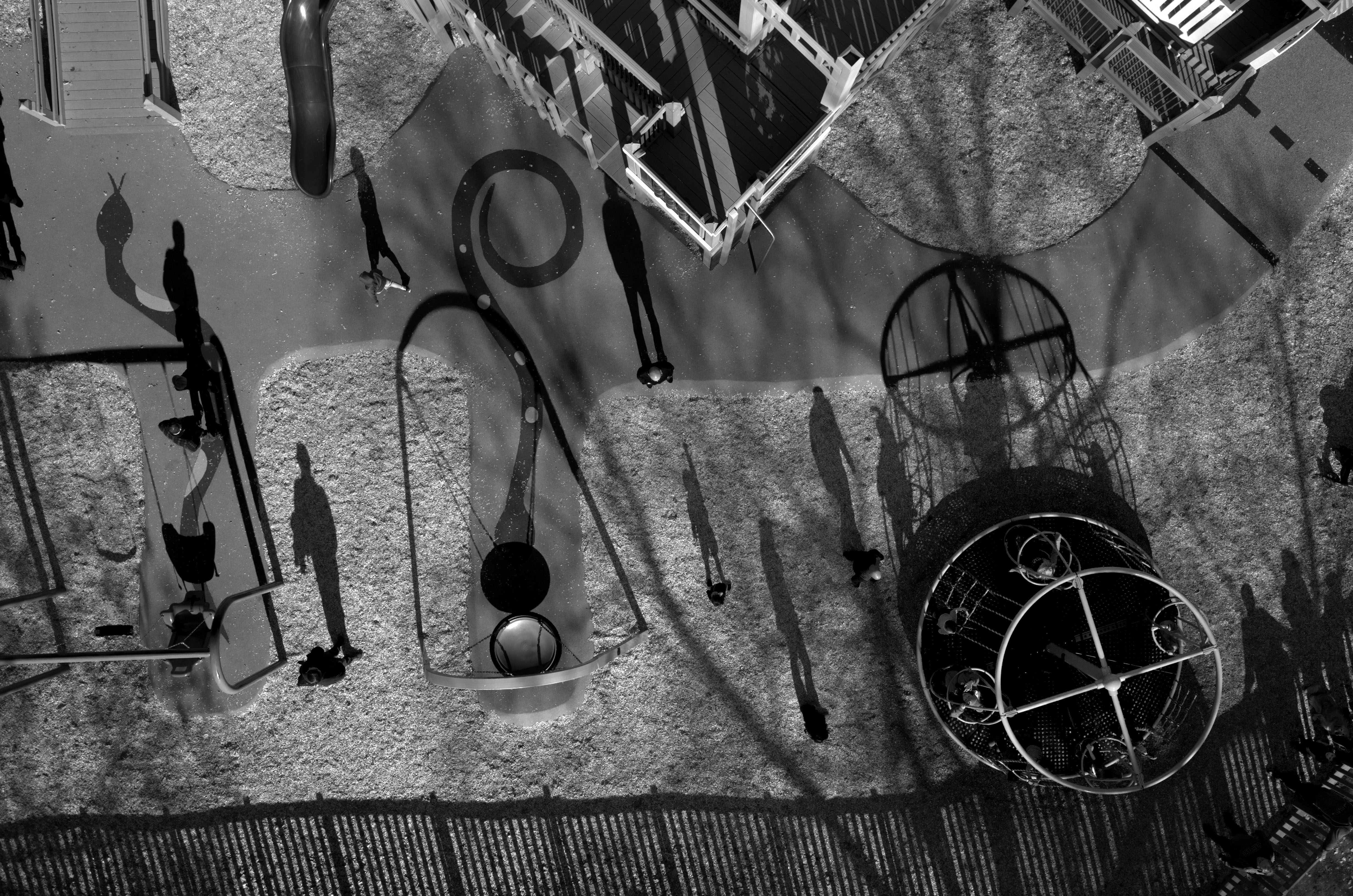 An aerial shot of a playground with shadows on the ground