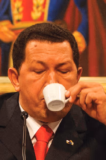 a man sips espresso from a cup