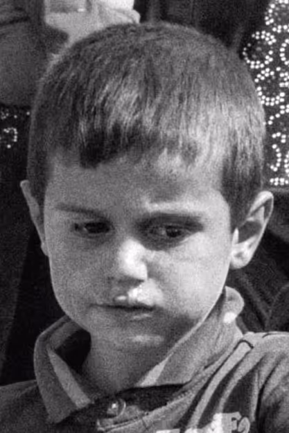a young boy looks down