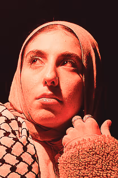 a young woman wearing a head scarf looks left