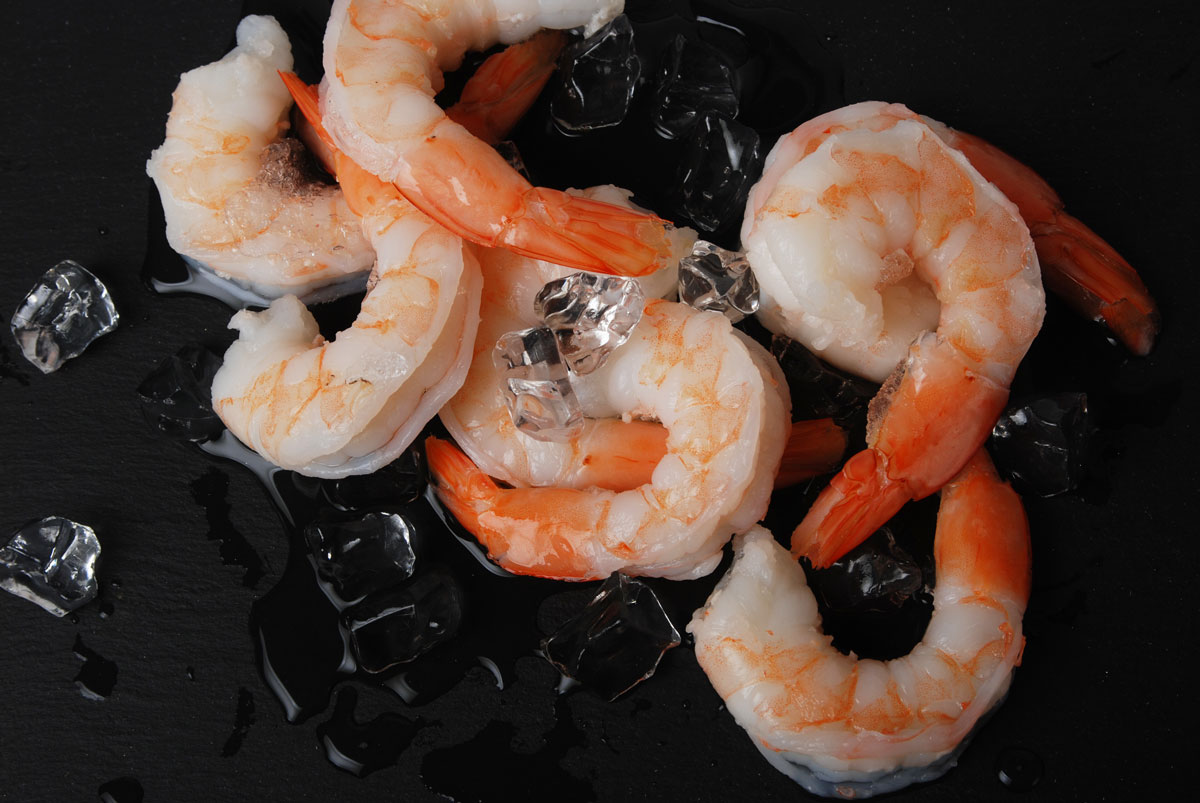 Icy Ocean cooked white shrimp, peeled and deveined tail on, on ice