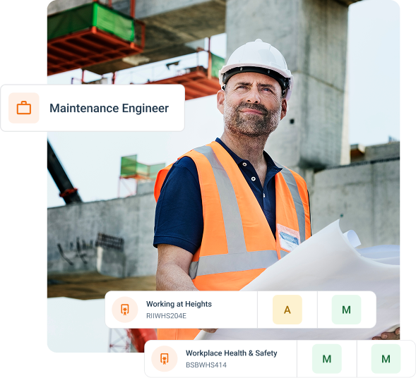 A tradie in hig-vis safety clothing looks confident as he stands smiling with arms crossed.