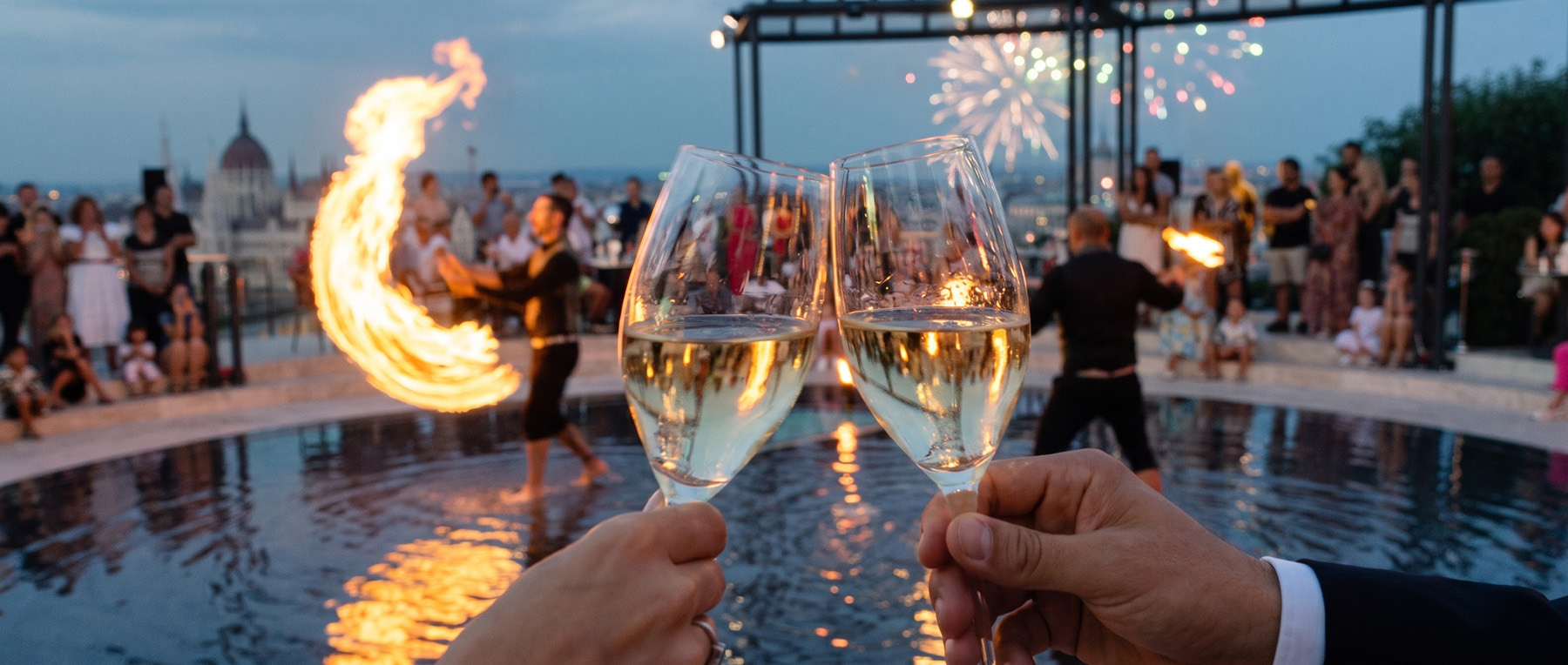 A champagne toast during the fire-juggling show by the pool on the Panorama Terrace at Aranybástya