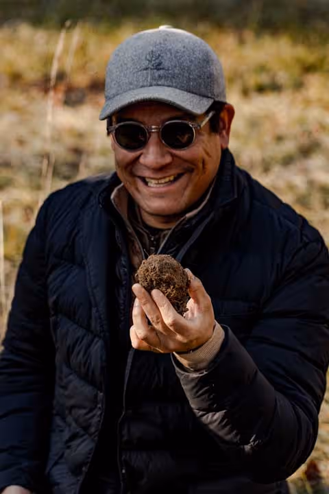 Farm owner showing unearthed black truffle