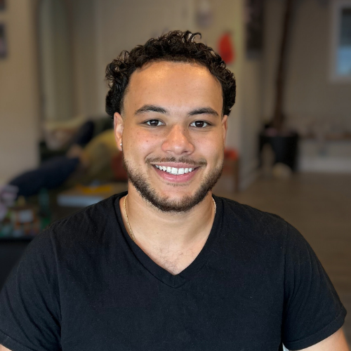 Picture of a man with glasses and a black polo with the TruFit AutoGlass logo smiling at the camera