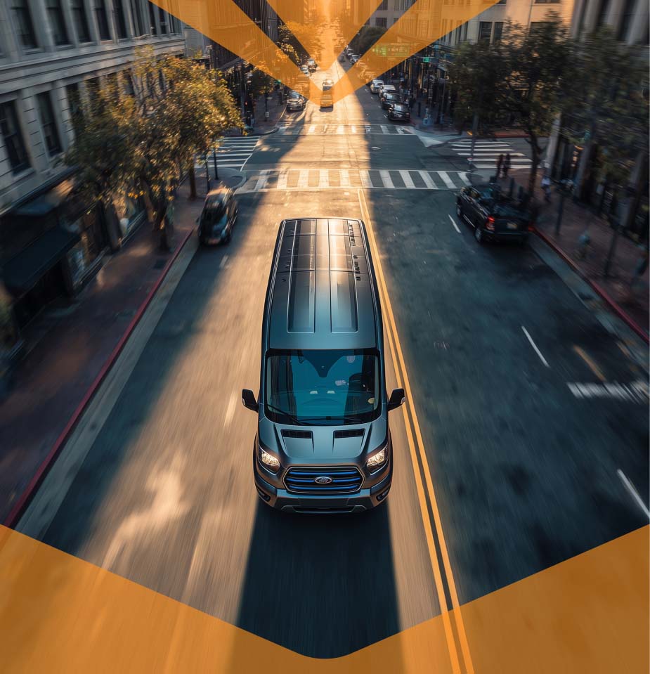 Van shuttle driving down city street