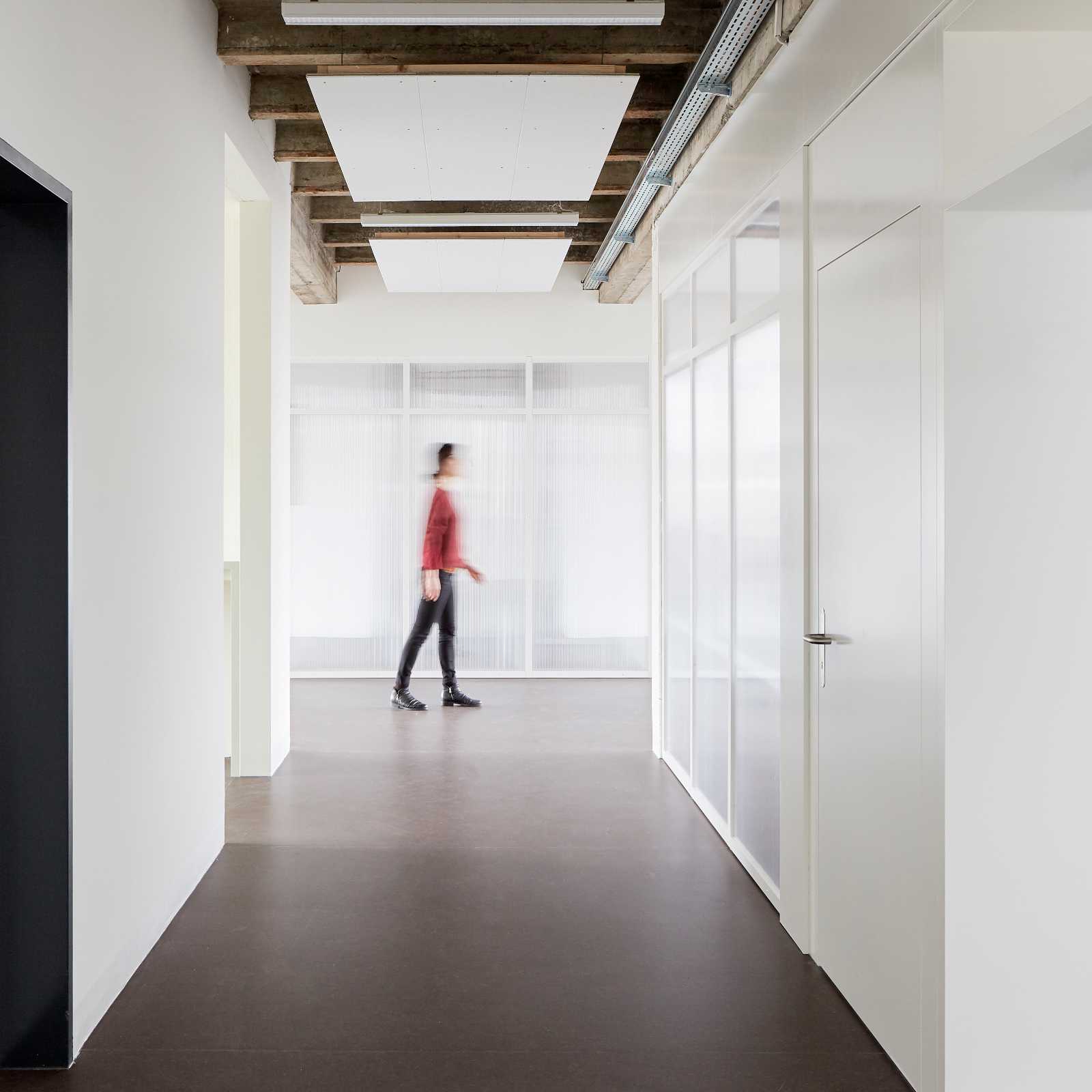 Conversion of former cubicle offices into a bright open-plan office with kitchen area and meeting room.