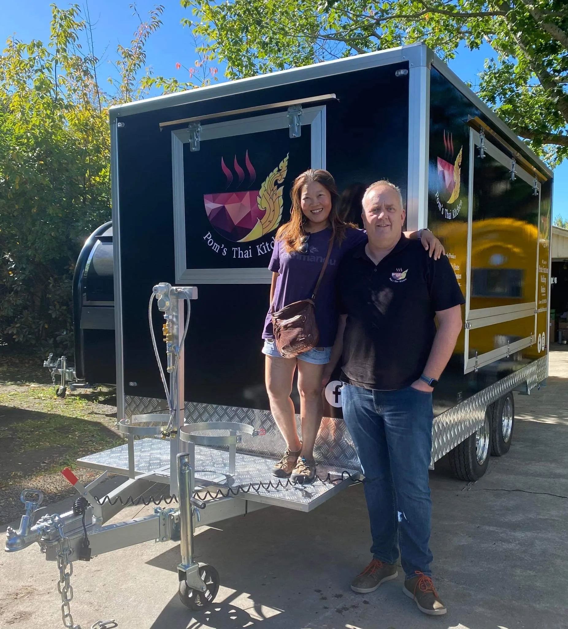 People standing next to food caravan