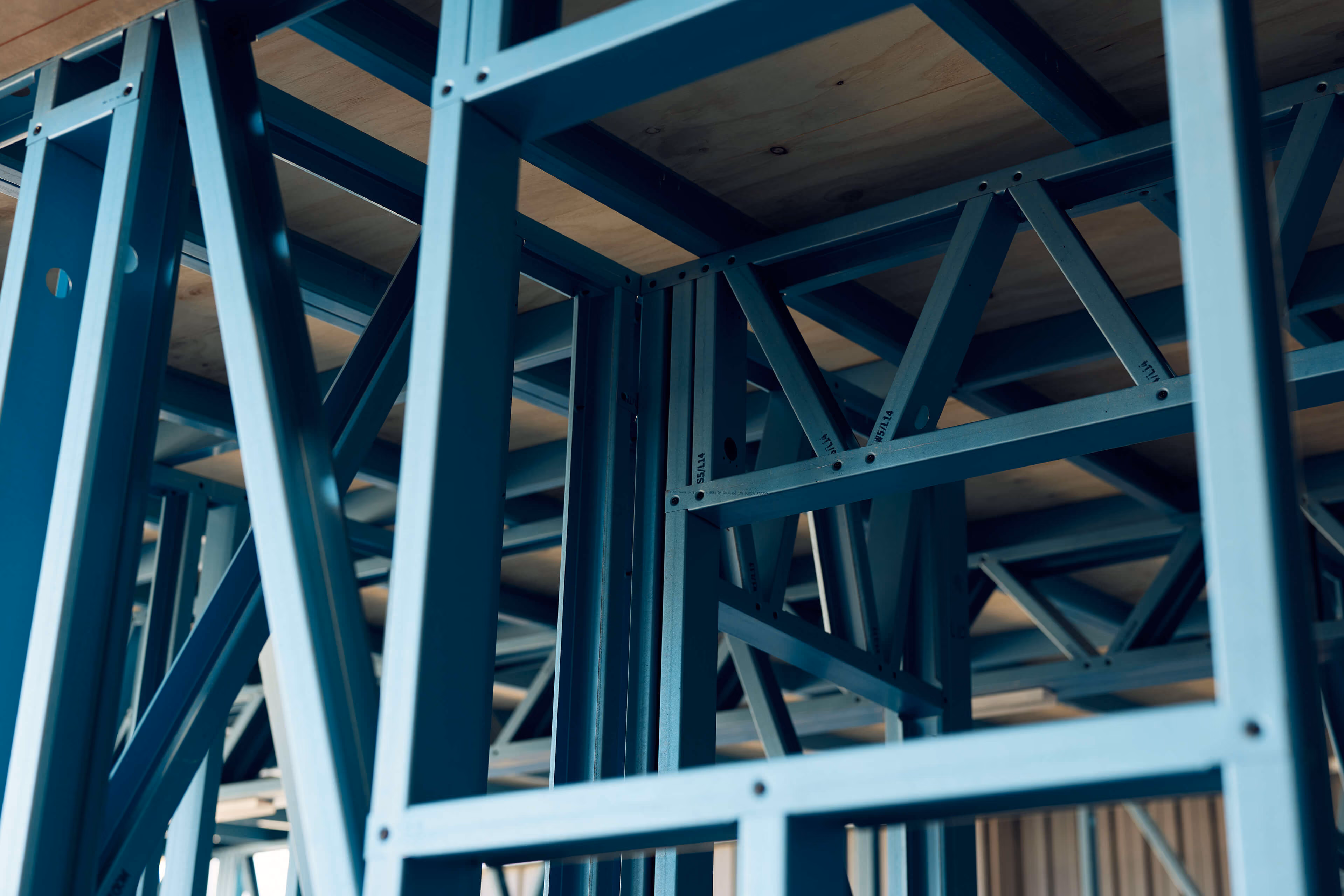 Close-up of blue Modify Steel framing, showing the steel members and bracing.