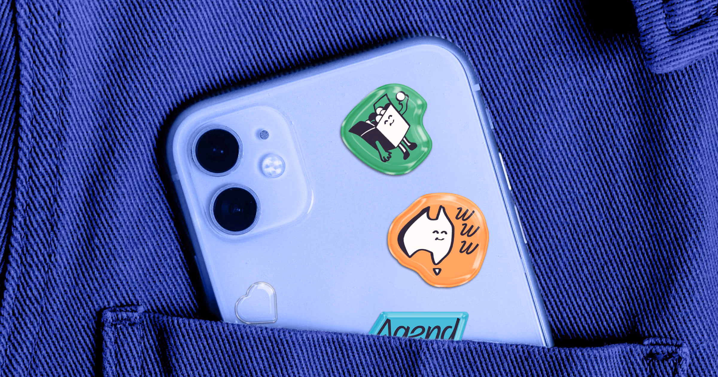 Agend’s character stickers on a lilac phone case, tucked into a blue workwear pocket. Playful brand merch with an Aussie twist.