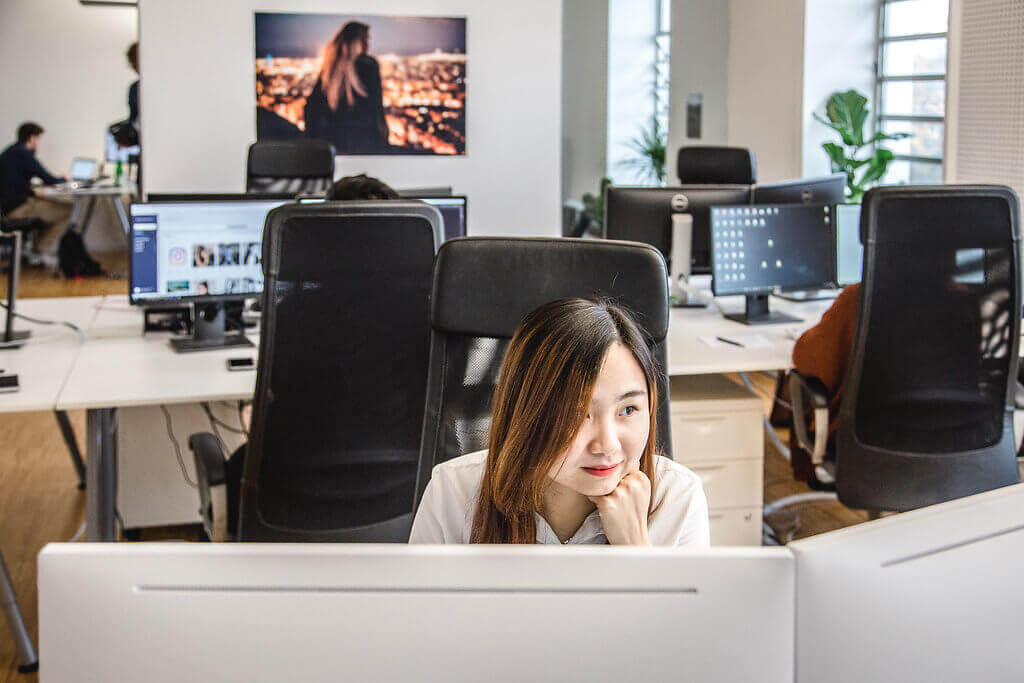 Team members working at the Influencer DB office