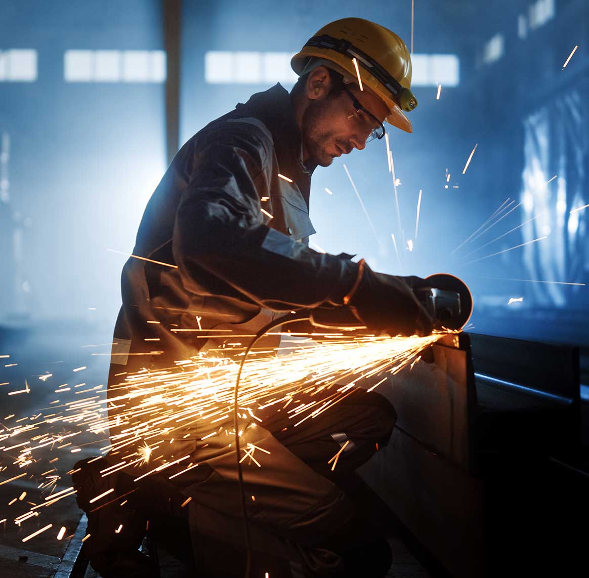 Man using grinder with sparks flying