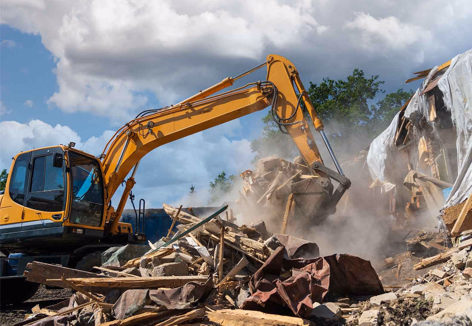 Digger demolishing building