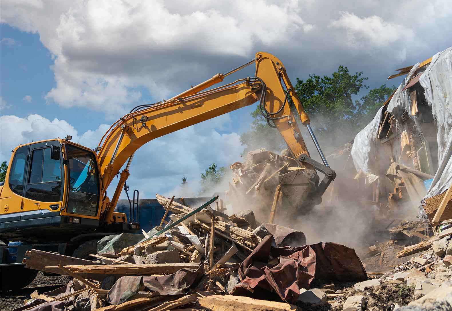 Digger demolishing building