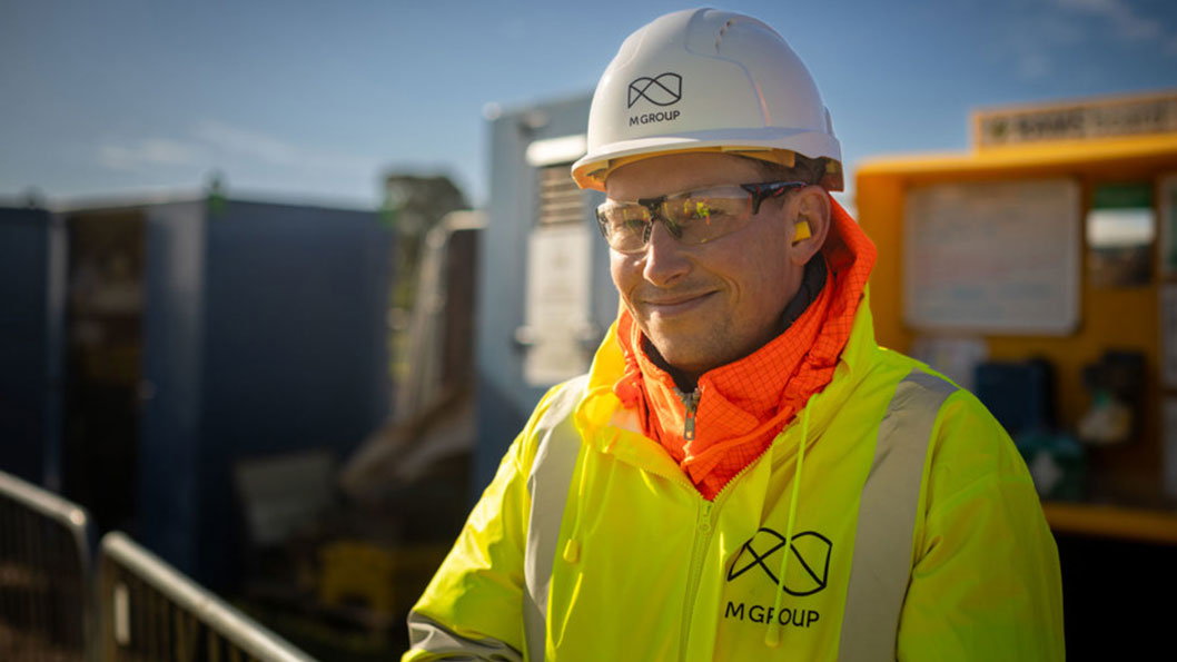M Group worker on site with full PPE