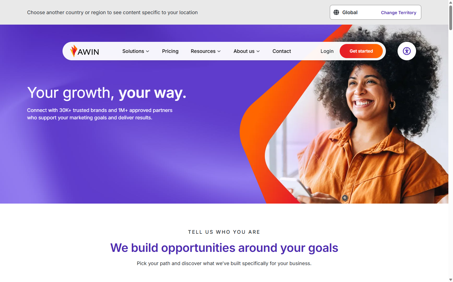 Awin homepage with a woman on a phone beside the headline ‘Your growth, your way’ and a message about connecting brands with partners.