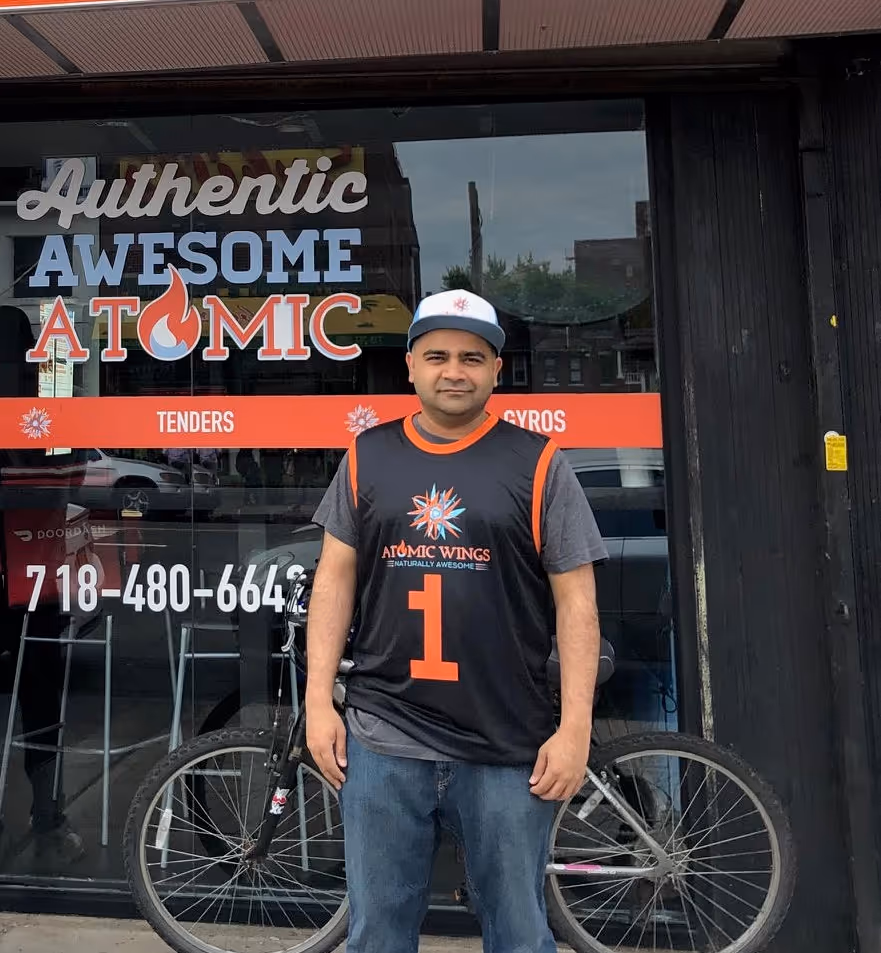 An image of Fahad Samad standing outside of his Atomic Wings shop