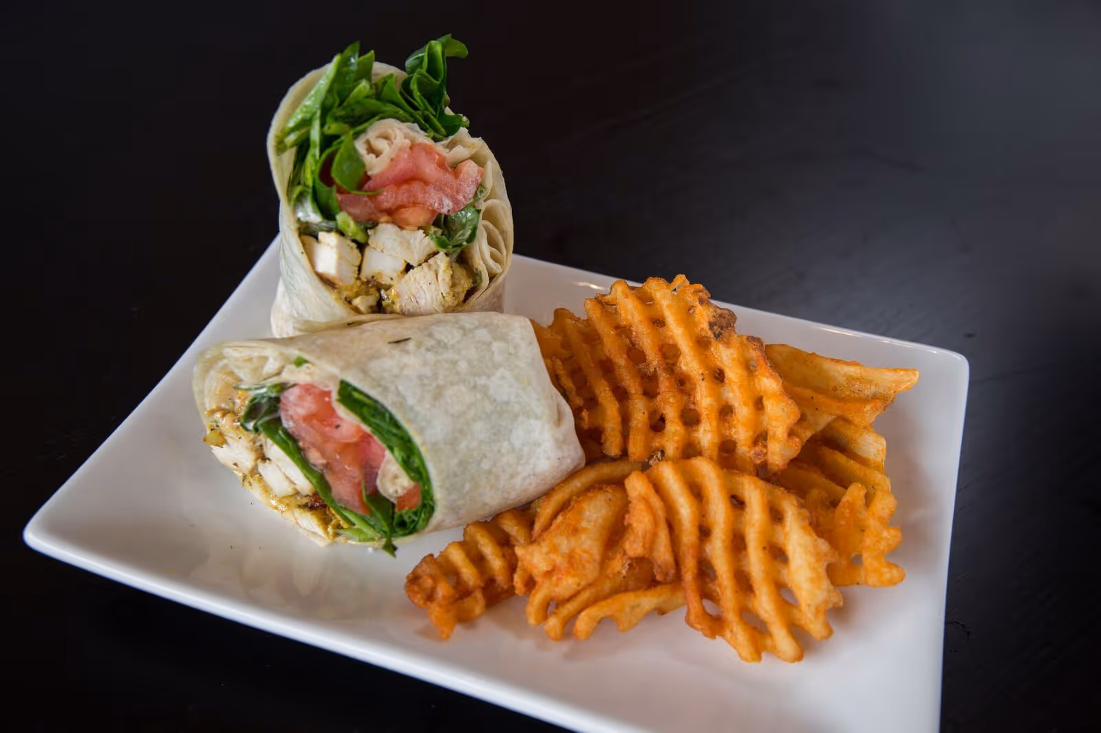 a chicken wrap and fries from atomic wings
