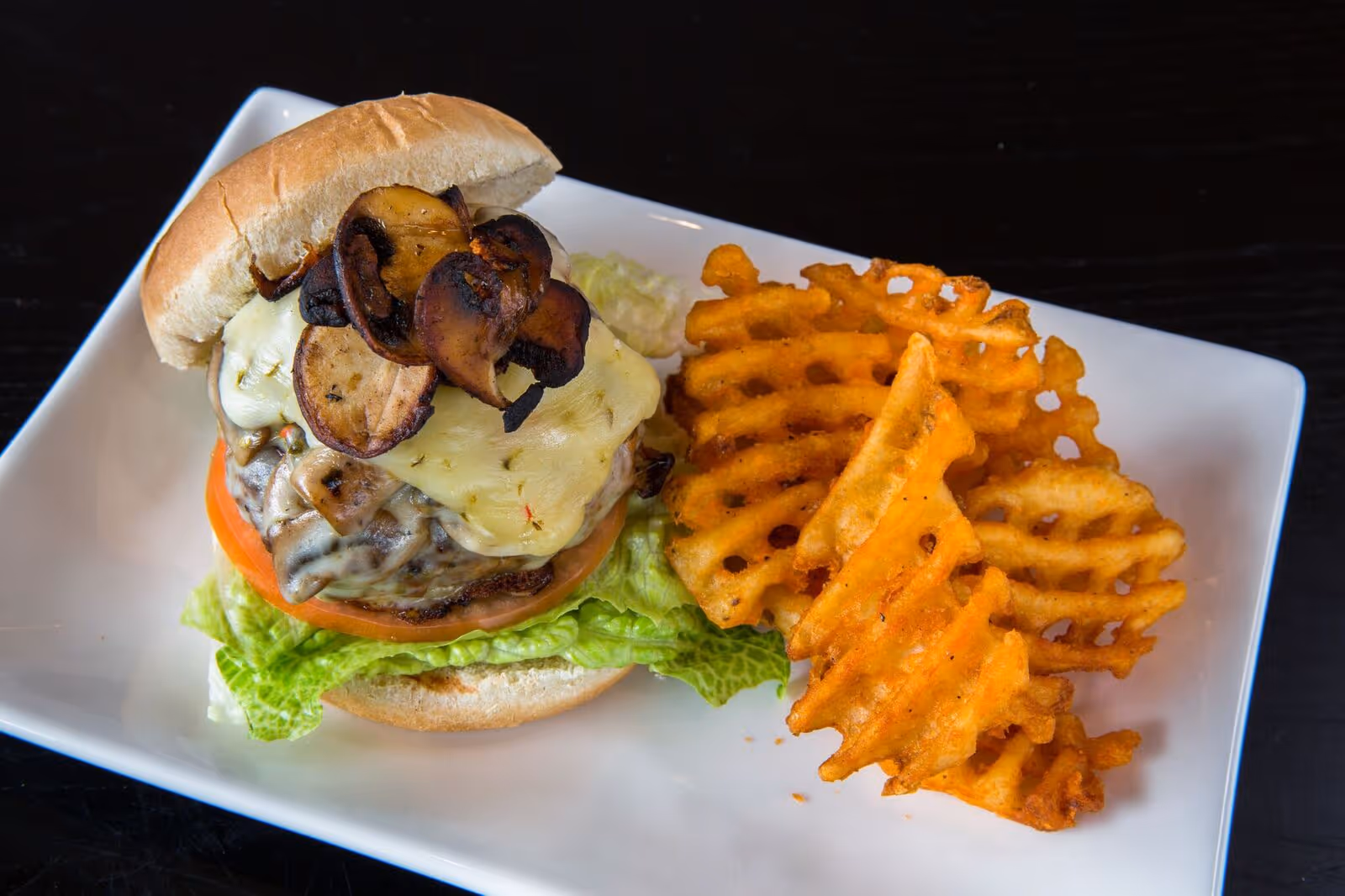 a burger and fries from atomic wings