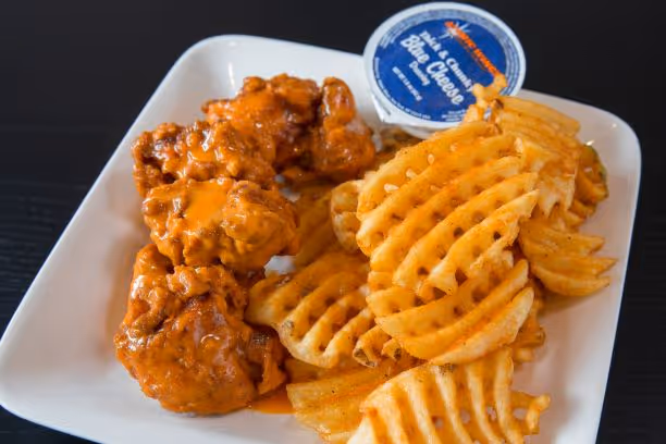 buffalo wings and waffle fries from atomic wings