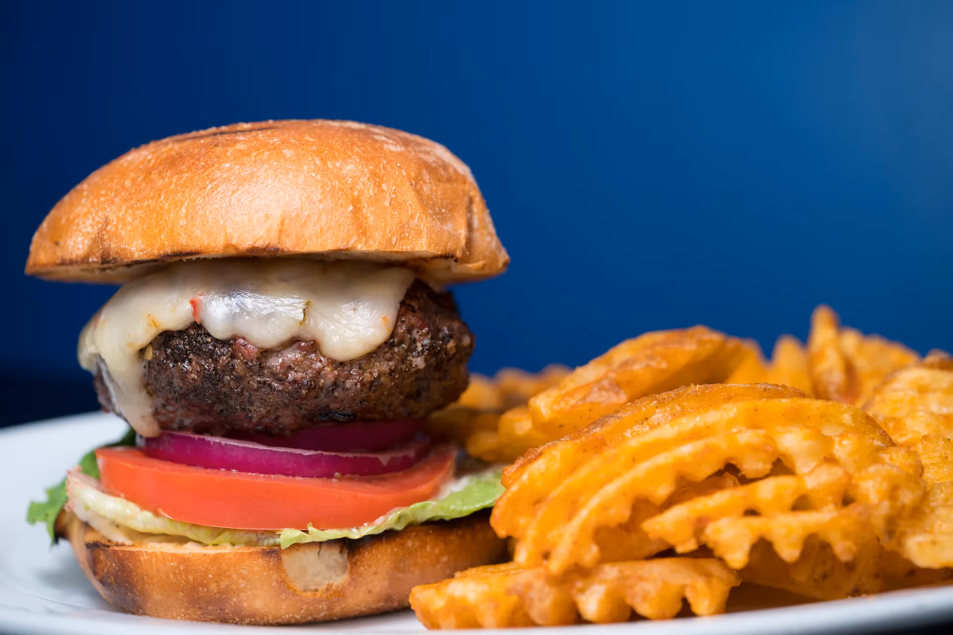 a burger and fries from atomic wings