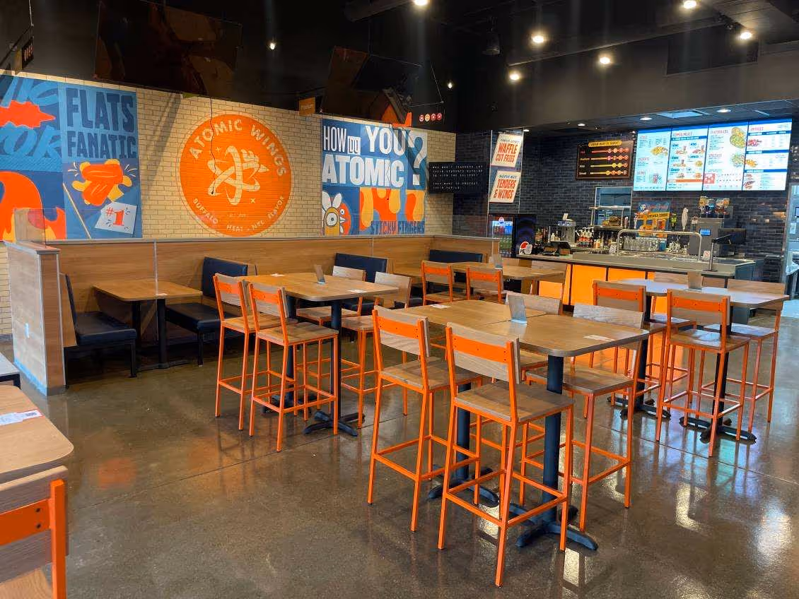 Inside shot of an Atomic Wings location, dining room with chairs and tables