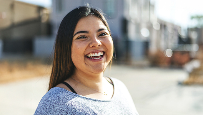 Young woman smiling outdoors