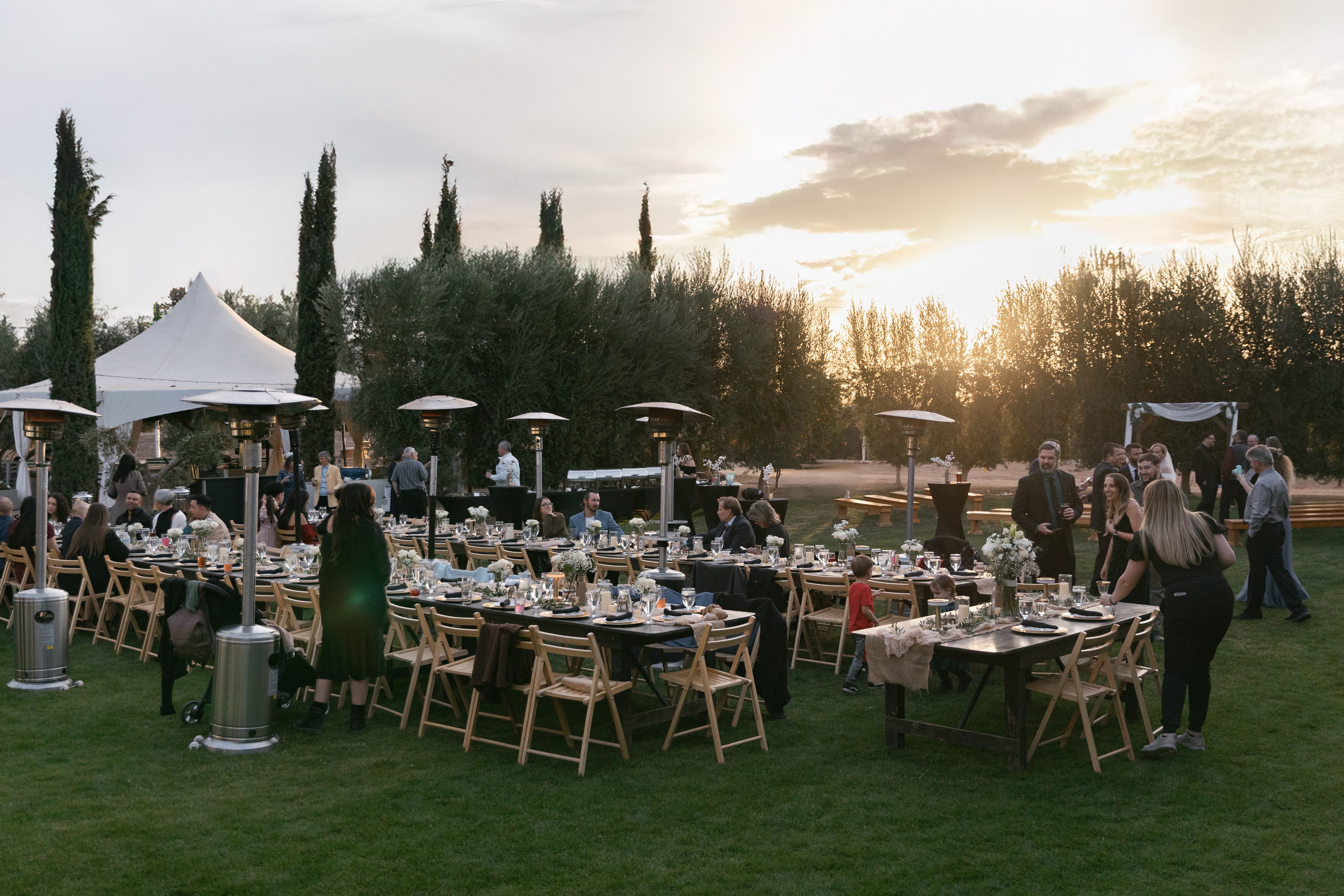sunset image of tables and people outside