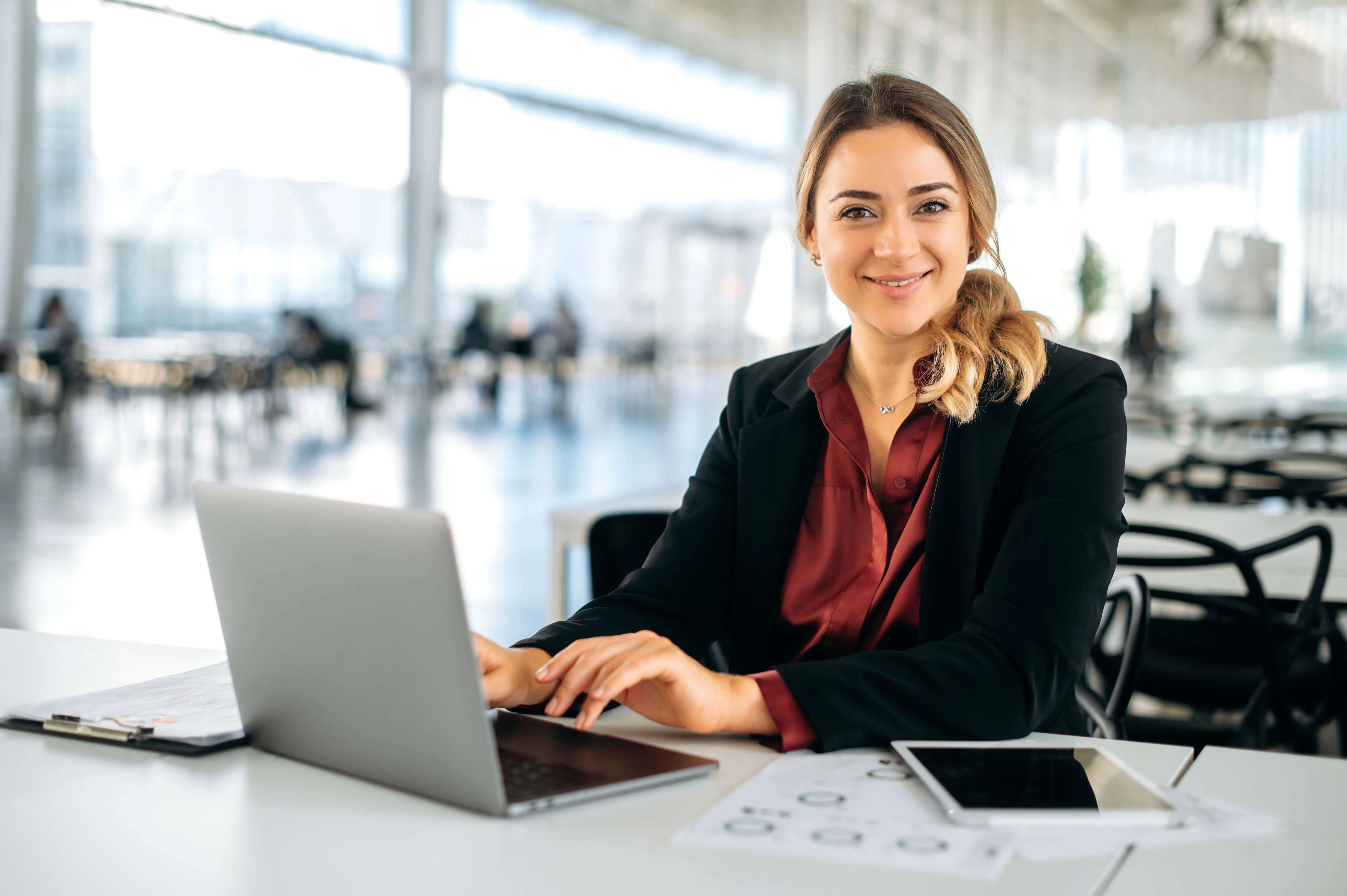 a woman sitting at a table with a laptop