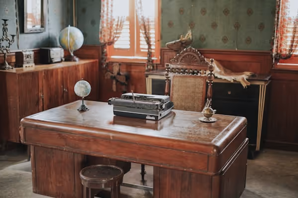 a desk with a typewriter on top of it