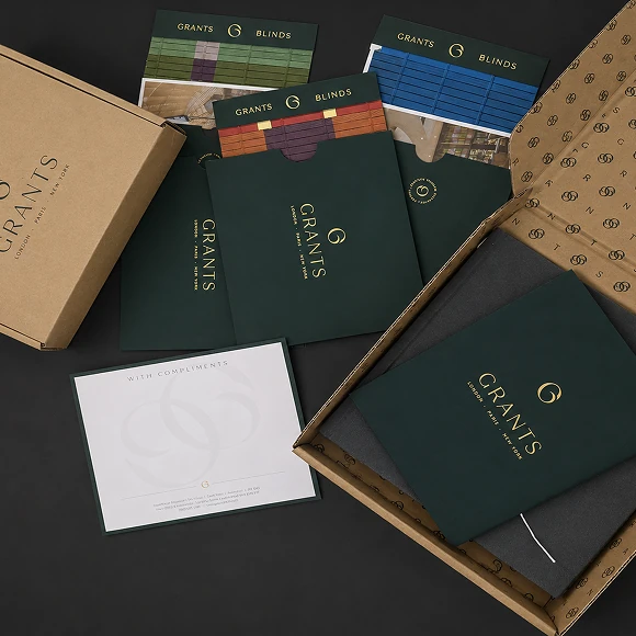 Branded packaging and materials for Grants Blinds, including folders, sample cards, and a compliments card.