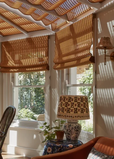 Finished bamboo Roman blinds installed in the conservatory, corner detail view
