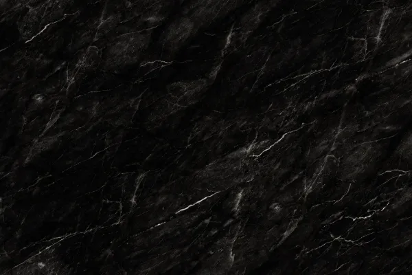 Dark black granite surface with subtle white and gray veining texture.