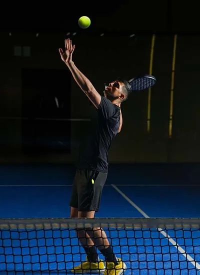 A padel player hitting a ball