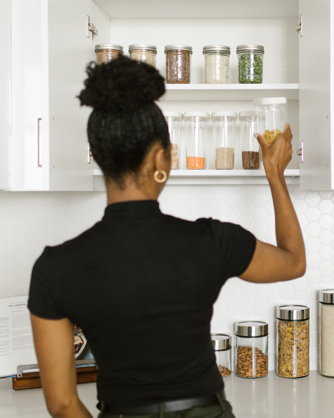 Modern, open-air room with floor-to-ceiling windows overlooking a calm ocean.   Wooden lounge chairs facing the water, with tall grasses near the edge.